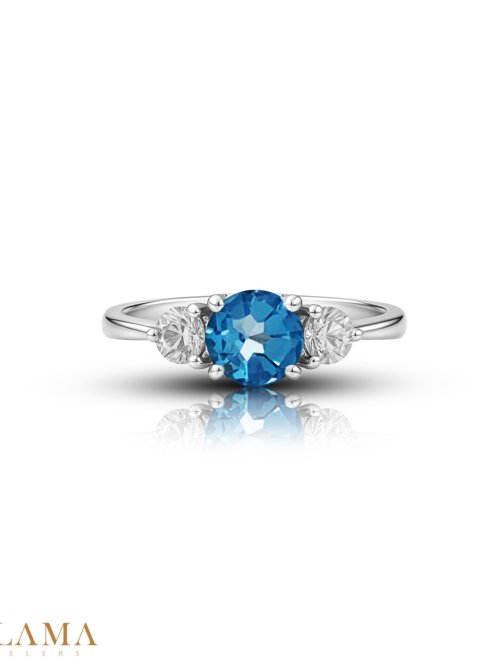 Crafted in sterling silver, this ring is set with a hand picked round blue topaz, framed by two American diamonds. Main Stone Blue Topaz Stone American Diamonds