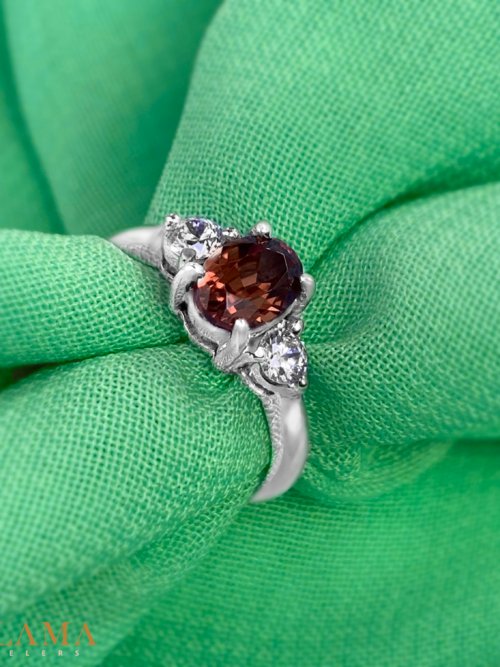 Crafted in sterling silver, this ring features a natural zircon with warm, earthy tones, framed by two sparkling American diamonds. Main Stone Natural Zircon Stone American Diamonds